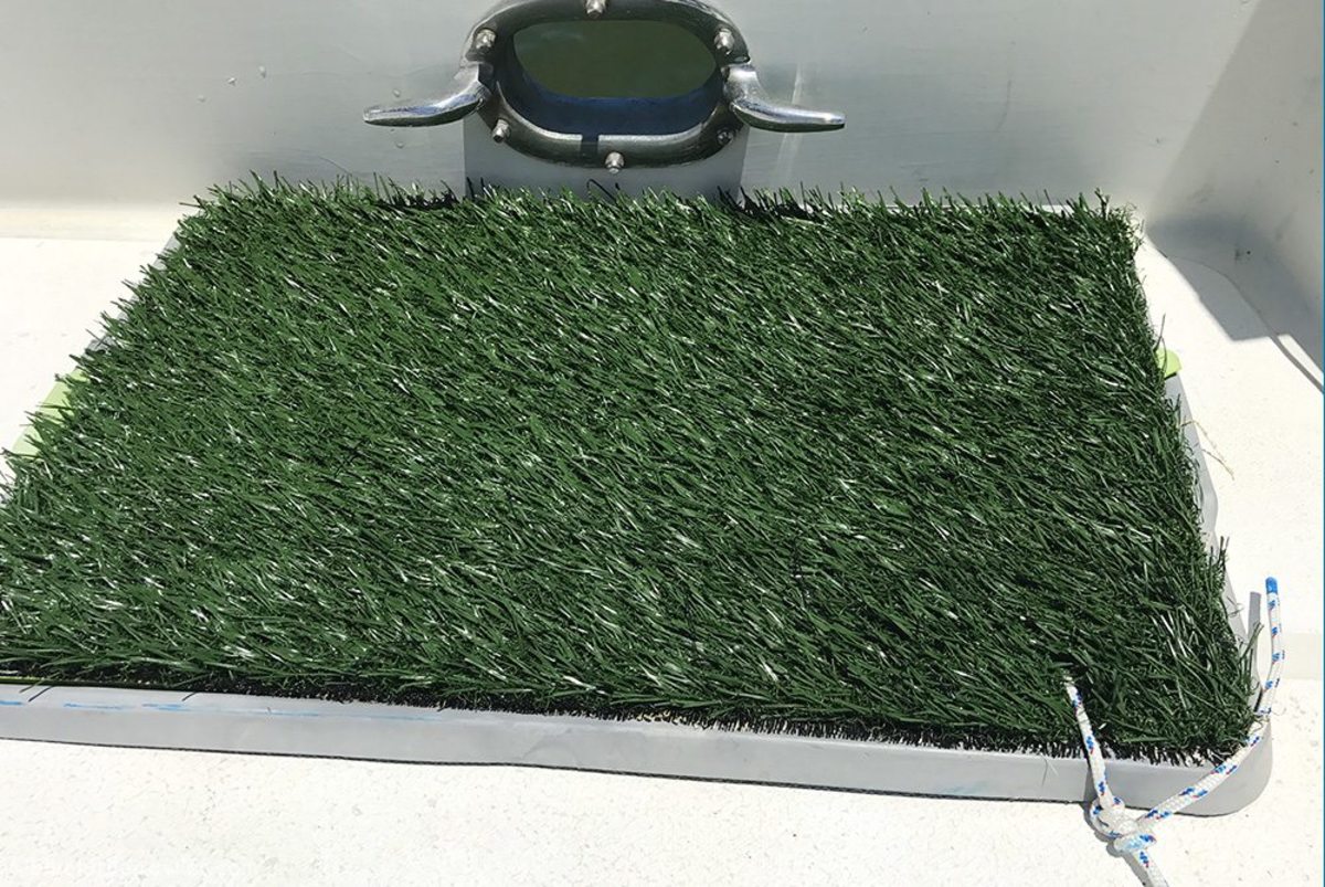 We use a potty patch like this one with a thin line attached through the grass mat and tray.