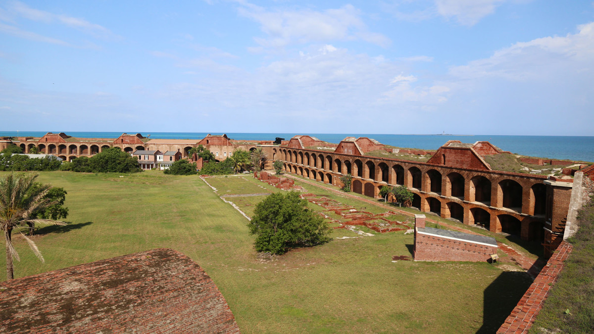 Top-level view of the parade ground, hot shot furnace, and remains of the officers’ quarters and kitchens.