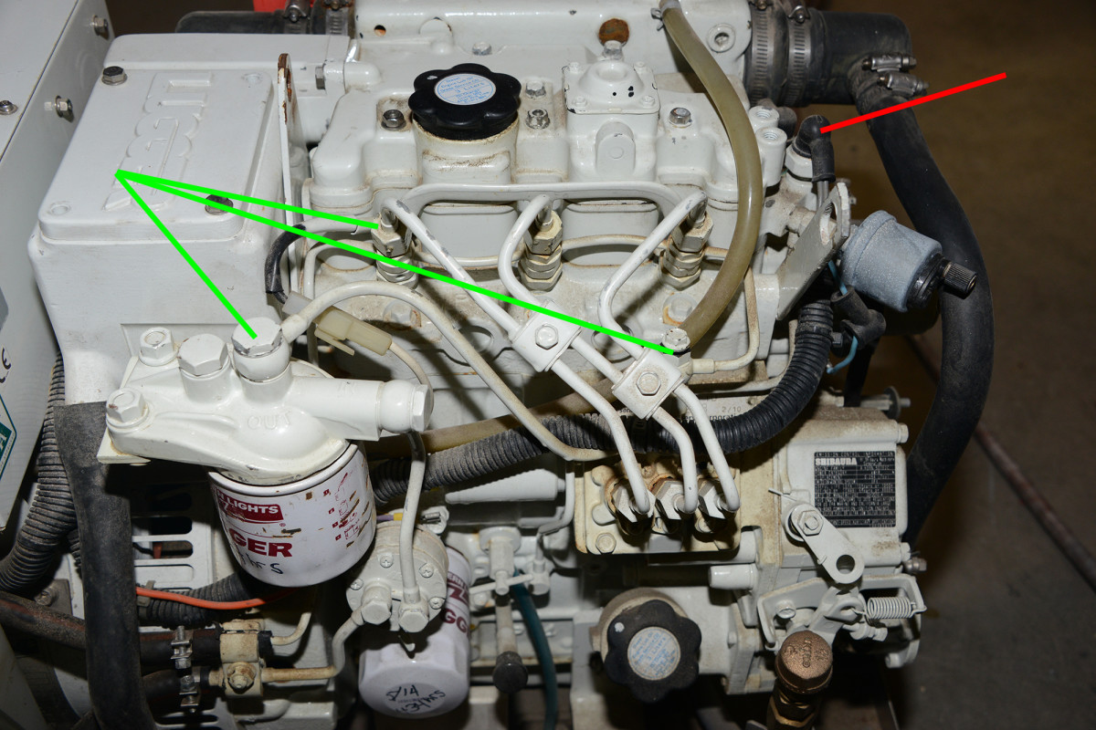 Generators rely on shutdown sensors to automatically stop the genset in the event of a problem. In some cases, the sender itself, such as this coolant temperature switch (red arrow), can fail. The green arrows indicate bleed points for the fuel system. 