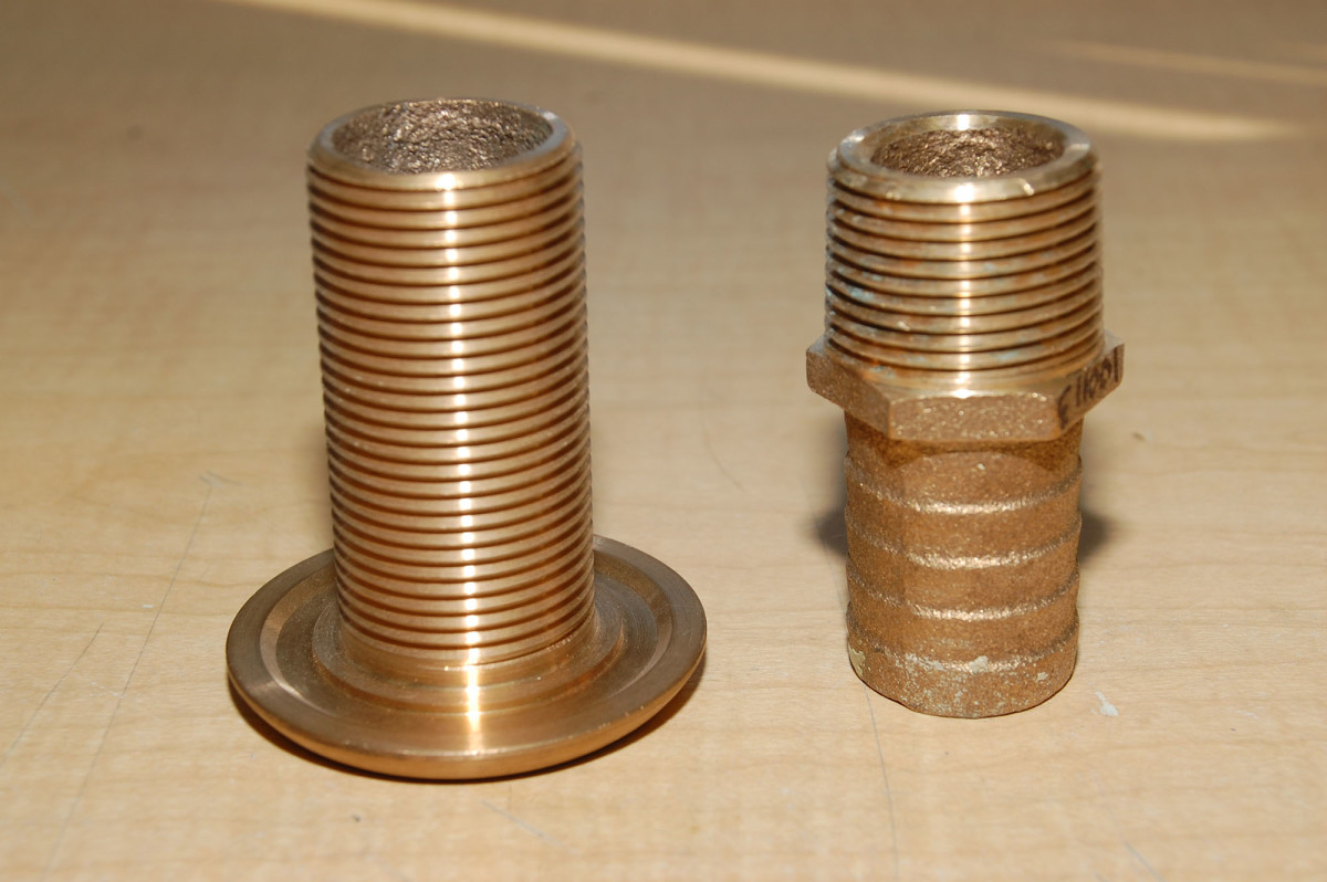 The thru-hull on the left has straight threads (NPS) while the hose barb on the right has tapered pipe thread (NPT). The two should never be mixed below the waterline.