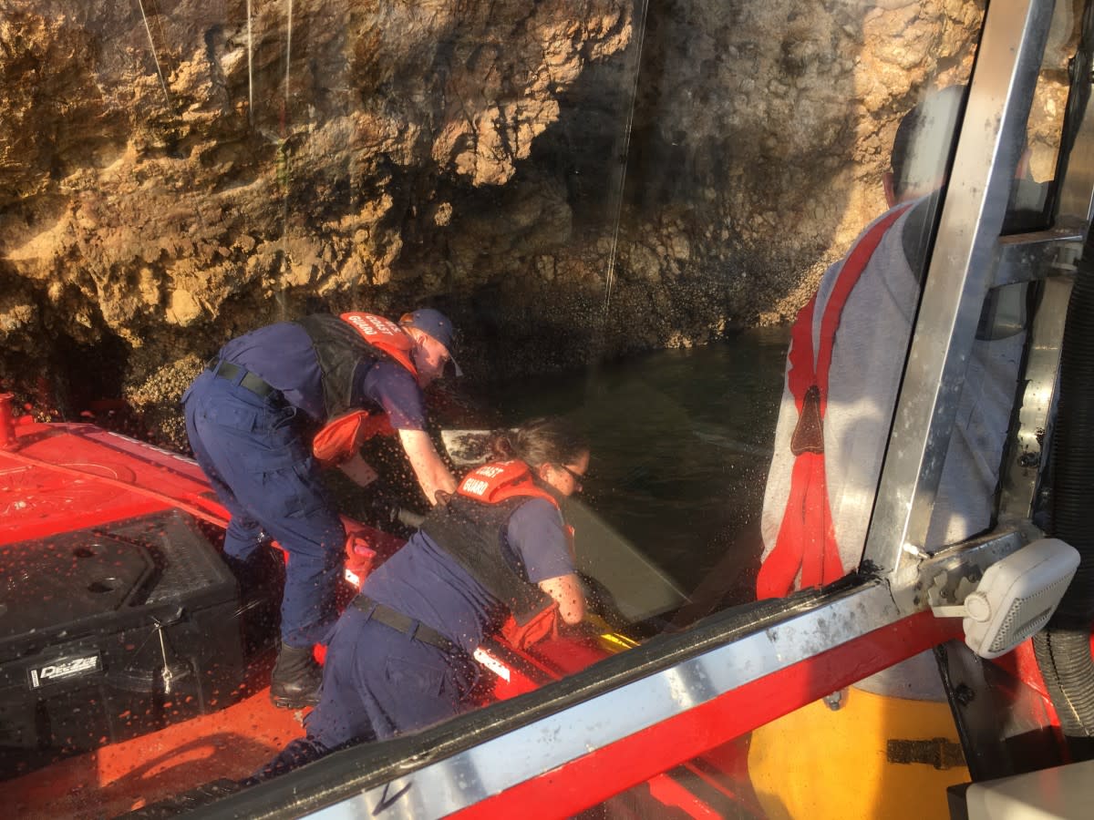 U.S. Coast Guard personnel recover debris.
