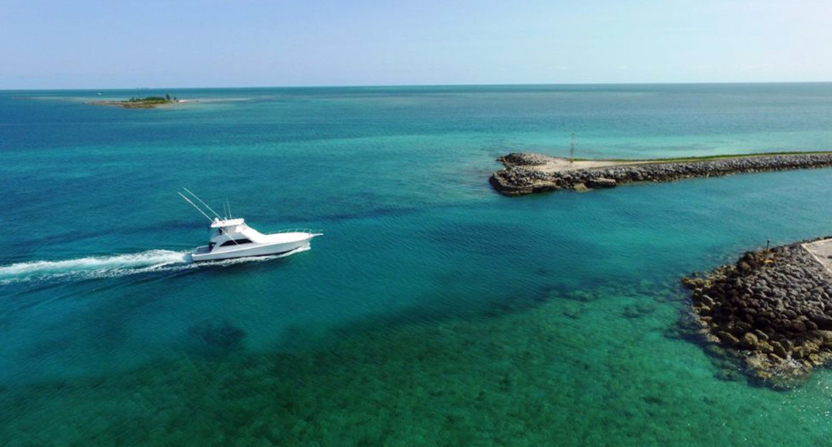 A sportfish boat navigates the entrance to Old Bahama Bay Resort Marina.