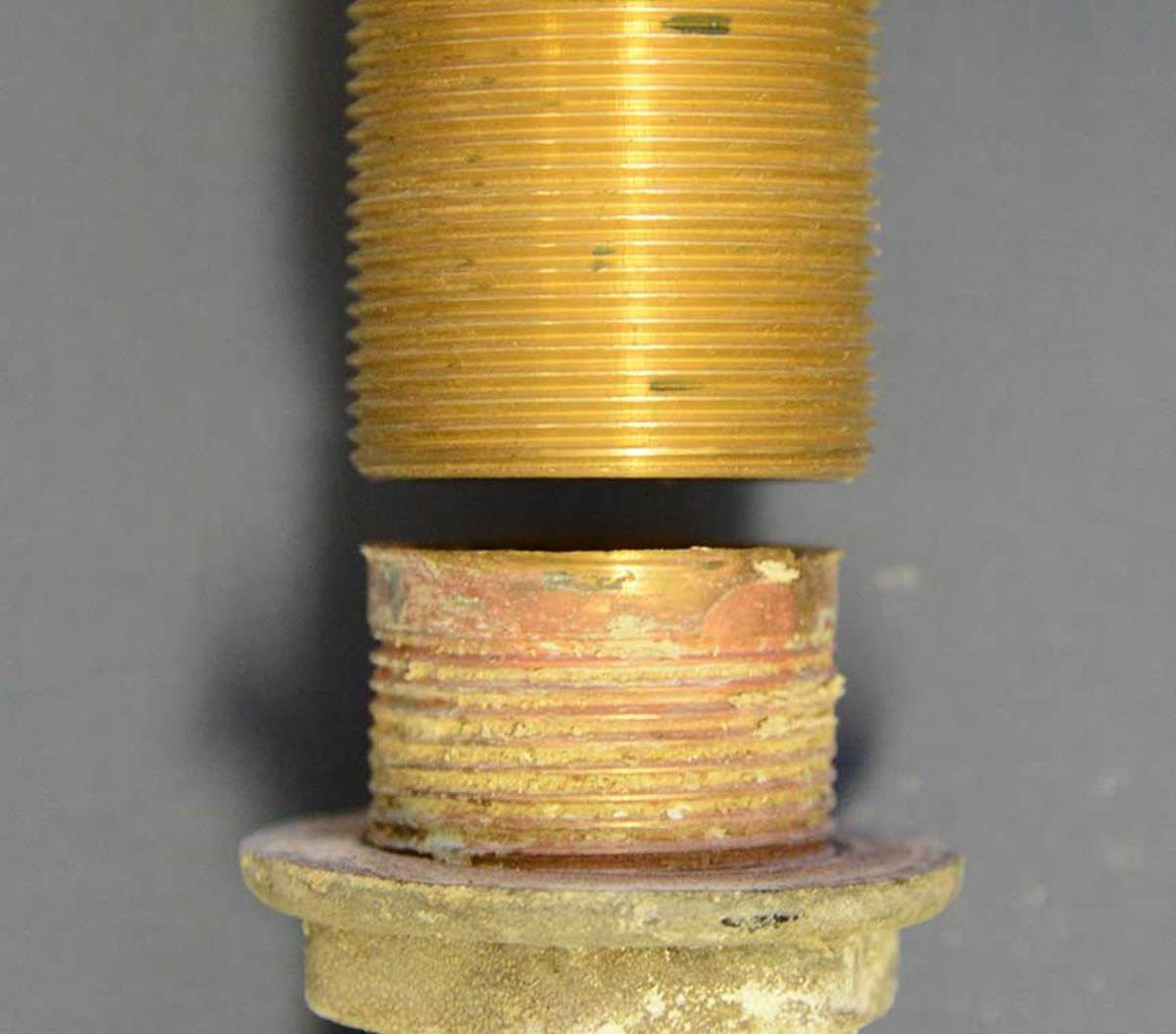 The color should be gold. The thru-hull on the right suffers from galvanic corrosion, as indicated by the pink color on the lower portion of the fitting.