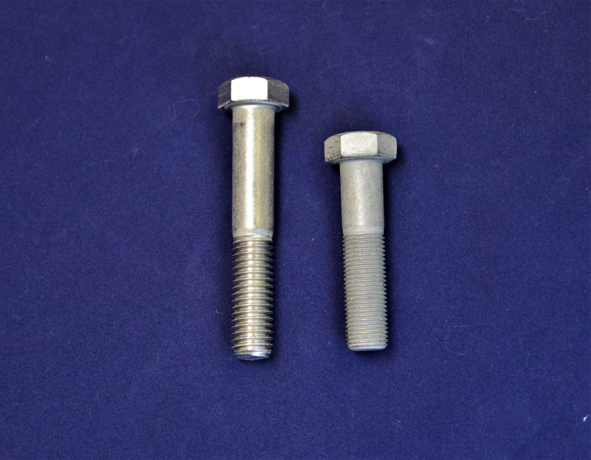 The stainless bolt on the left has standard (coarse) threads, while the Grade 8 carbon steel on the right has fine threads. Grade 8 is substantially stronger than stainless and is required in some applications, such as shaft couplings. 