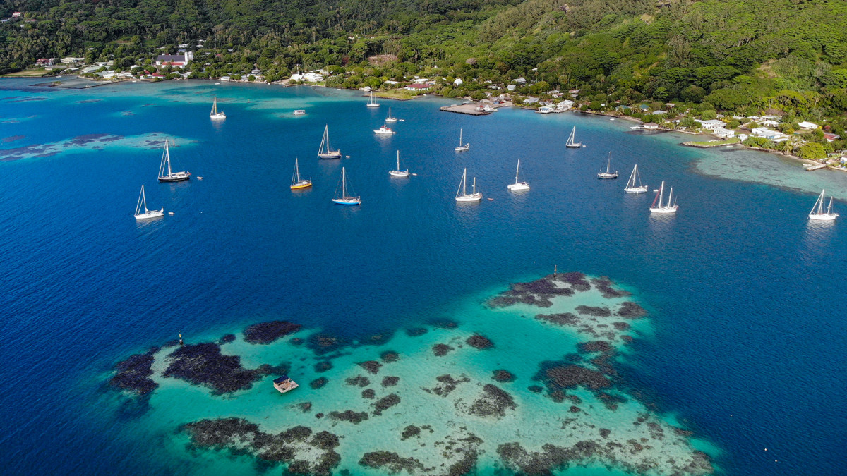  Liberty II at anchor in the Gambier Islands in French Polynesia, surrounded by sailboats.