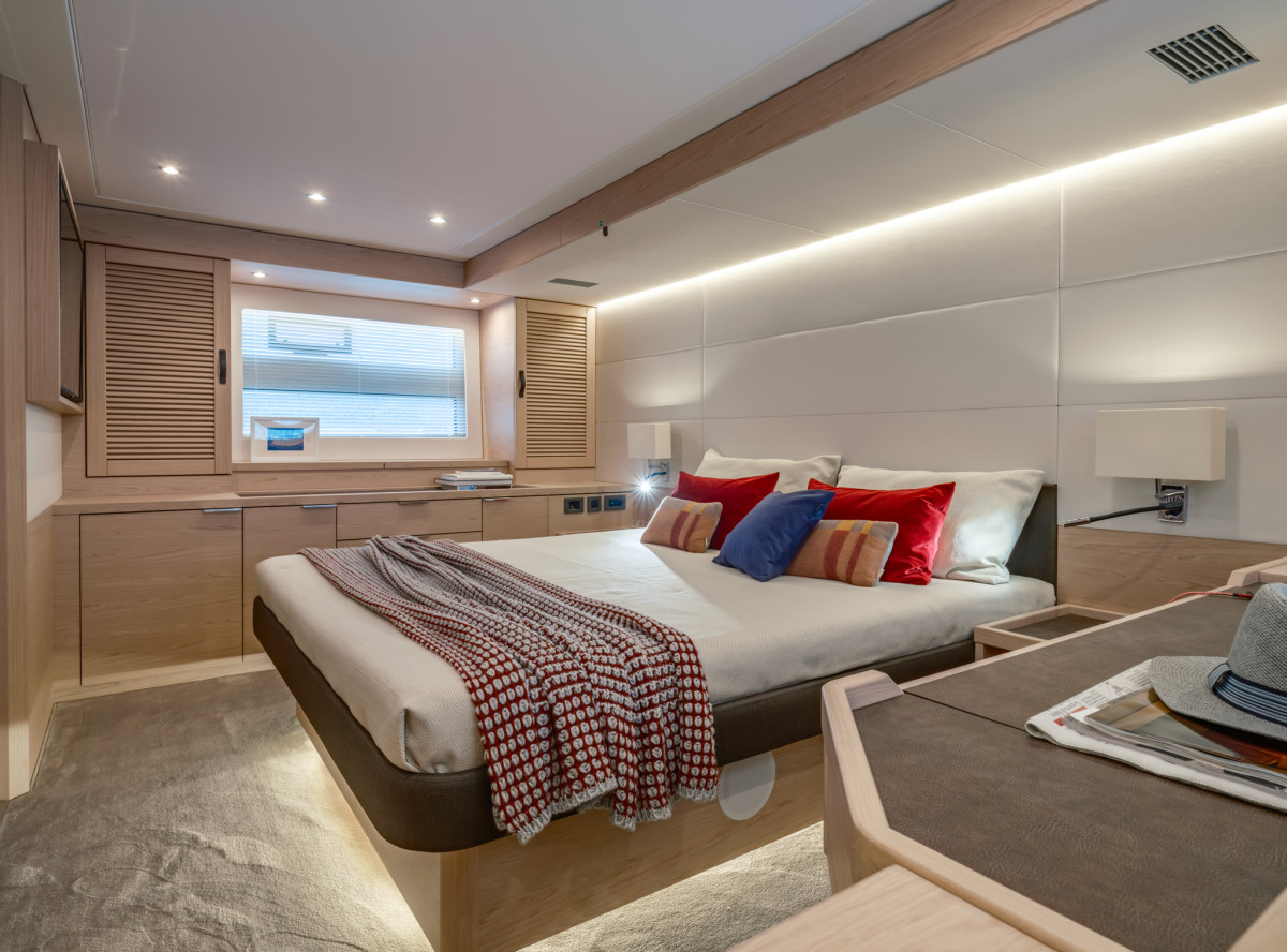 The full-beam master stateroom amidships has deep stowage, a vanity/desk and an ensuite bathroom. In the optional four-stateroom layout, the space is configured as two guest staterooms and the forward stateroom becomes the master stateroom.