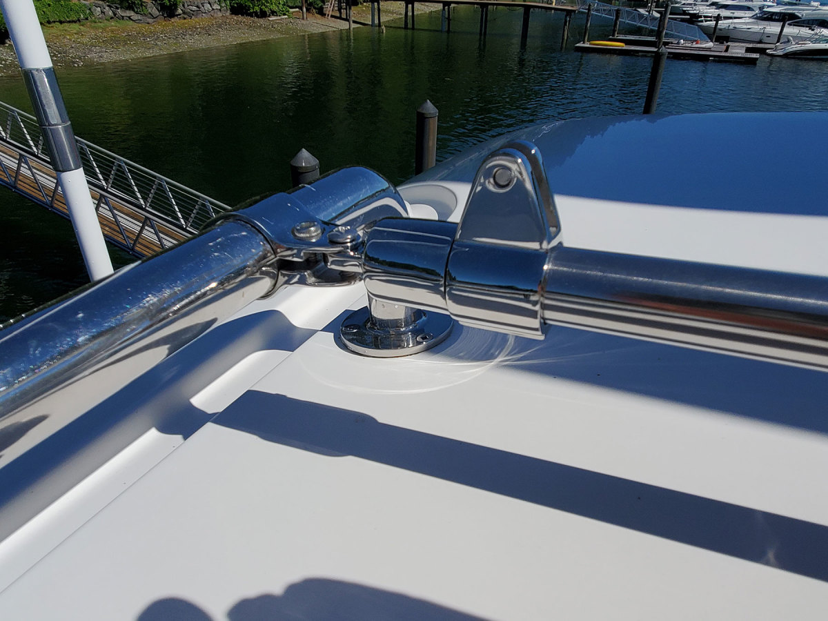 The stainless tubes that support the panels are attached to the handrails using standard Bimini hardware.