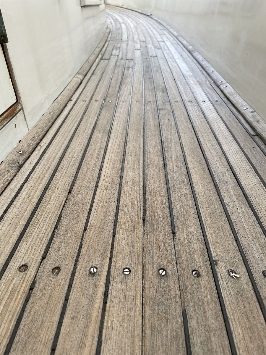 These teak decks are past their prime. The surface has worn away, exposing screw heads and the bottom of the caulking groove. Chances are that water has penetrated the teak and is working its way into the deck core. 